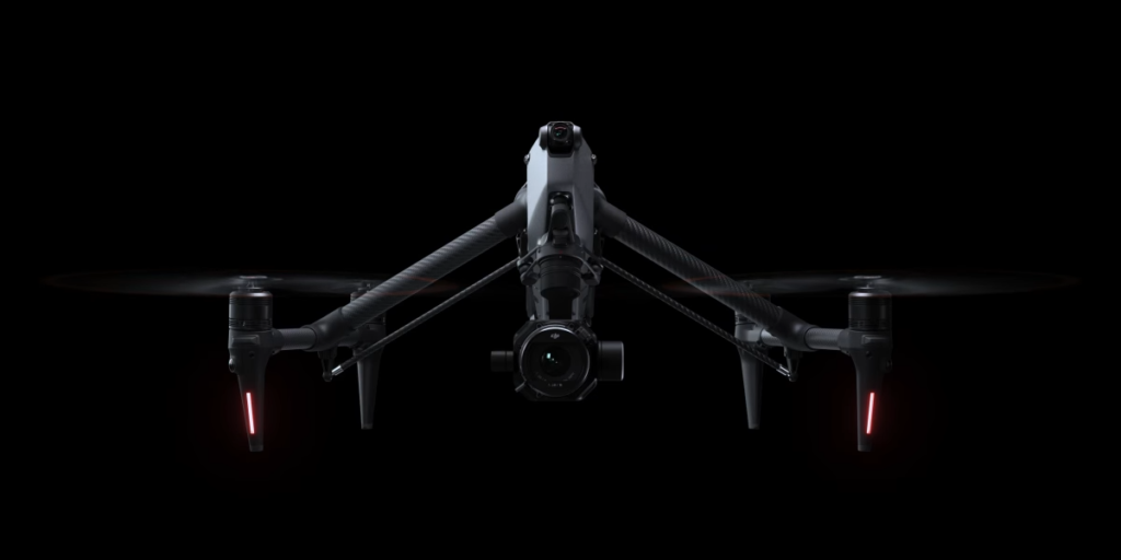 "DJI Inspire 3 8K cinema drone in flight over Nigeria", "Dual-operator DJI RC Plus controllers for Inspire 3", "DJI Inspire 3 TB51 battery charging hub with eight batteries", "Zenmuse X9-8K Air gimbal camera with interchangeable lens"